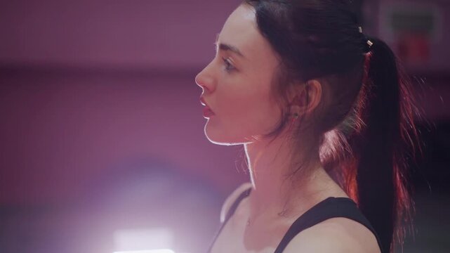 studio gym profile caucasian woman poised, rimlit ponytail and glistening sweat. subject breathes through cooldown, checks posture, and visualizes comeback frames read like a series of roles