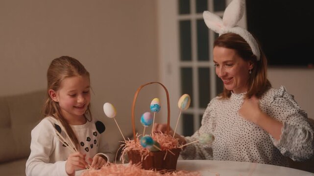 Mother and Daughter Celebrate Easter, Decorating Eggs and Sharing Joy