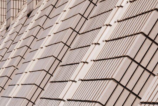 Tilted building walls create unusual, interesting architecture. Play of lines and angles emphasizes modern, artistic character of the structure.
