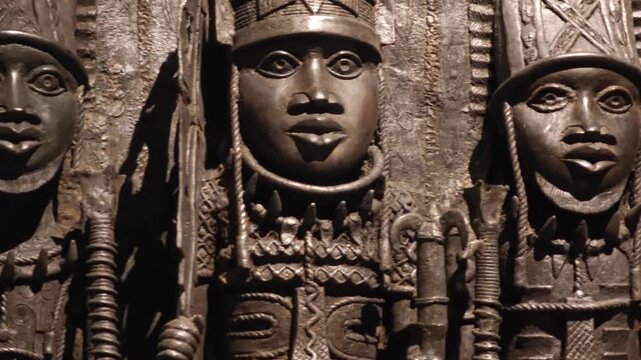 An ethnic art display featuring African masks, sculpted busts, and statuettes from Central Africa. These ritual and cultural objects showcase traditional craftsmanship.