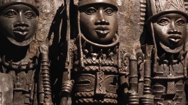 An ethnic art display featuring African masks, sculpted busts, and statuettes from Central Africa. These ritual and cultural objects showcase traditional craftsmanship.