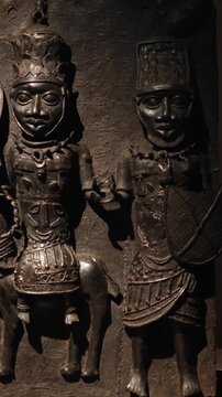 Exhibition of Central African cultural artifacts: intricately crafted ritual masks, wooden sculptures, and figurines representing the continent's ethnic artistry.