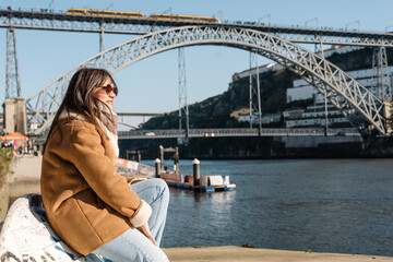 Woman traveling in porto viewing dom luís i bridge © Jorge