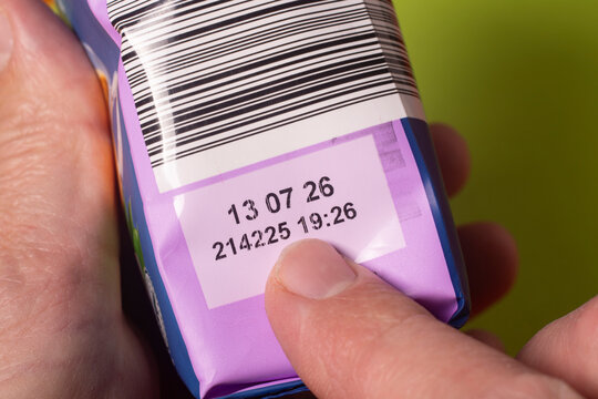 A man checks the expiration date on a package in a store