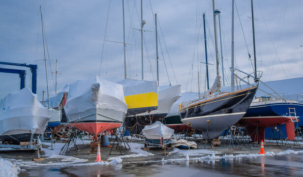 Sailboats in Winter:  Boats in dry dock wait for spring on a cloudy January day in New England. 
