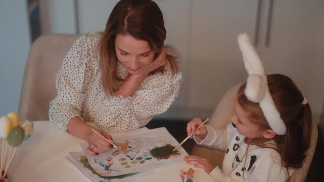 Mother and Daughter Painting Easter Themed Artwork Together, Celebrating the Holiday with Creativity and Joy