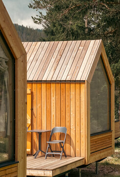 Wooden houses in a camping site among forests and mountains.