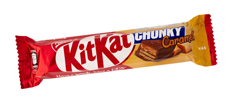A Kit Kat chunky caramel candy bar is displayed on a simple background. It shows the wrapper and brand name clearly. It is set for a quick snack or sweet treat