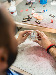 A dental technician creates a denture model in a dental office.
