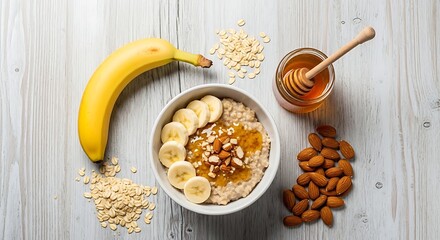 Fototapeta premium Healthy Oatmeal Breakfast with Banana, Almonds, and Honey.