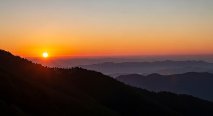 Obraz premium Breathtaking mountain sunset with layered hills and vibrant sky
