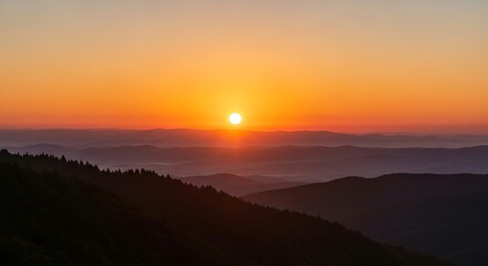 Obraz premium Breathtaking mountain sunset with layered hills and vibrant sky