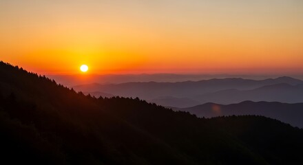 Obraz premium Breathtaking mountain sunset with layered hills and vibrant sky
