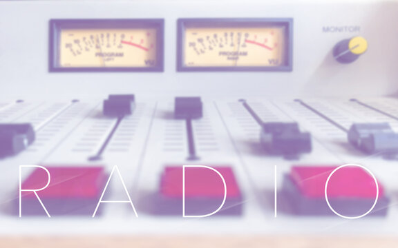 Radio mixing console and &ldquo;RADIO&rdquo; text in a broadcast studio