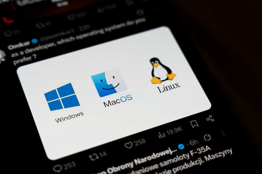 Warsaw, Poland - Feb 5, 2026: Display showing three popular operating system logos: Windows, MacOS, and Linux, emphasizing the choices available for developers in technology.