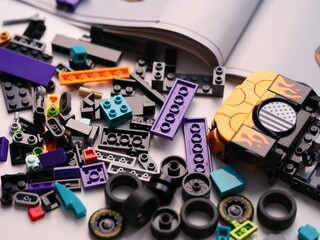 Obraz premium Tambov, Russian Federation - January 01, 2026 Lego Speed Champions Nascar Next Gen Chevrolet Camaro car kit build in progress with bricks, pieces and instructions