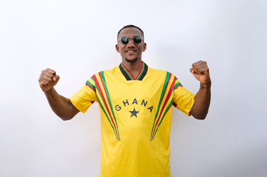 A Ghanaian African football supporter is cheering a goal scored