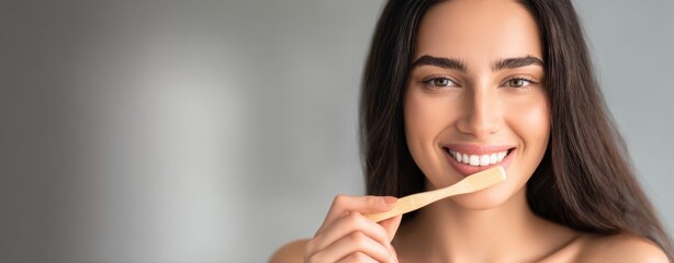 The Smiling Woman Holding a Wooden Spatula Near Her Teeth in Studio Portrait