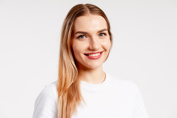 Obraz premium Smiling young blonde woman posing for a happy professional portrait headshot