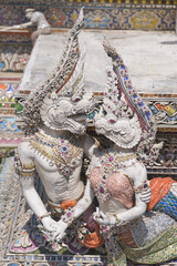 The contemporary stucco artwork in the Ordination Hall of Wat Pariwat Ratchasongkhram blends concepts related to beliefs and philosophy. Located at Bangkok city in Thailand.