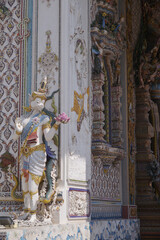 The contemporary stucco artwork in the Ordination Hall of Wat Pariwat Ratchasongkhram blends concepts related to beliefs and philosophy. Located at Bangkok city in Thailand.