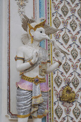 The contemporary stucco artwork in the Ordination Hall of Wat Pariwat Ratchasongkhram blends concepts related to beliefs and philosophy. Located at Bangkok city in Thailand.