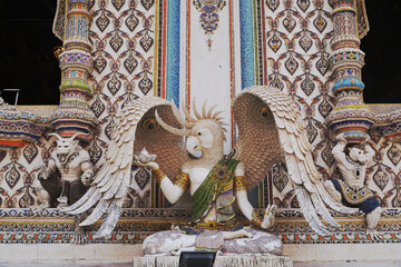 The contemporary stucco artwork in the Ordination Hall of Wat Pariwat Ratchasongkhram blends concepts related to beliefs and philosophy. Located at Bangkok city in Thailand.