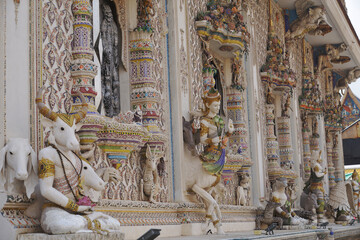 The contemporary stucco artwork in the Ordination Hall of Wat Pariwat Ratchasongkhram blends concepts related to beliefs and philosophy. Located at Bangkok city in Thailand.