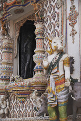 The contemporary stucco artwork in the Ordination Hall of Wat Pariwat Ratchasongkhram blends concepts related to beliefs and philosophy. Located at Bangkok city in Thailand.