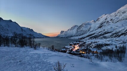Fototapeta premium Winter Twilight over a Snowy Fjord Village