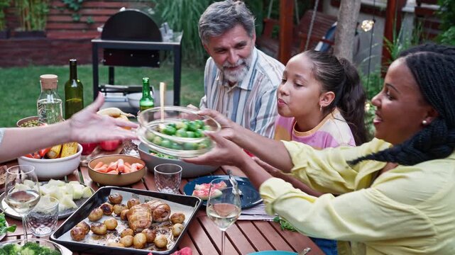 Multigenerational Family Sharing Food at Outdoor Dinner Table