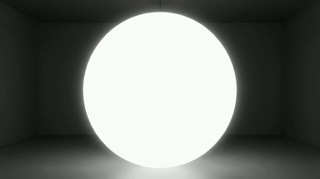 Glowing light bulb with warm filament in dark background