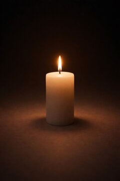 Burning white candle providing light and hope