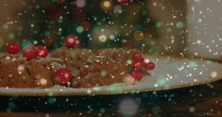Showing white plate holding bundt cakes on wood table, being dusted with powdered sugar and berries