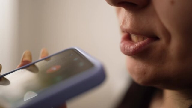 Close-up of woman talking on audio call, speaking, using smartphone for online communication at home