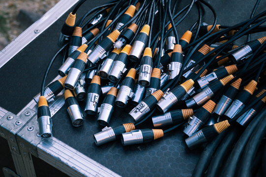 Ethercon network cables with rj45 connectors are gathered on a road case, highlighting equipment connectivity for audio-visual operations, broadcast production, and live event technical setups