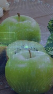 Vertical video: HUD pulsing, overlay sliding across two green apples, halved kiwi showing freshness