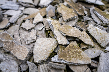 Broken stone slabs and gravel on ground surface
