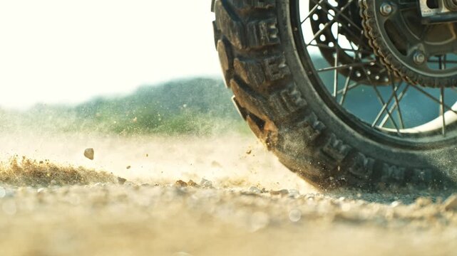 Super Slow Motion Shot of an Off-Road Motorcycle Spinning Its Rear Wheel and Throwing Dirt Into the Air. Captured at 1000fps to Highlight Power, Motion, and Explosive Terrain Impact. Speed Ramp Effect