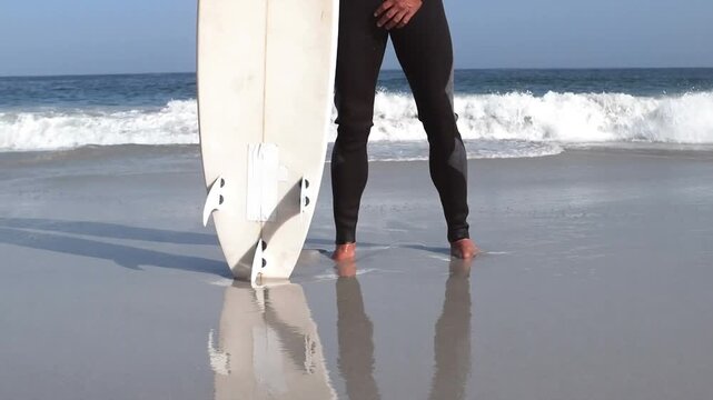 Animation of do it for them over surfer with board on beach