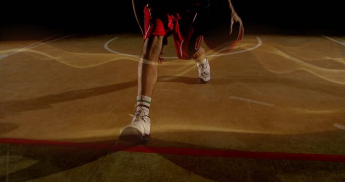 Basketball player initiating crossover dribble on court for sports training, golden waves pulsing