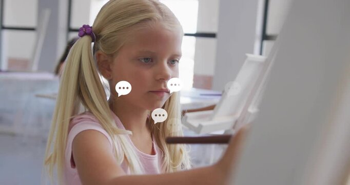 Blonde girl painting in class at easel, chat bubbles emerging around brush fading, peer observing
