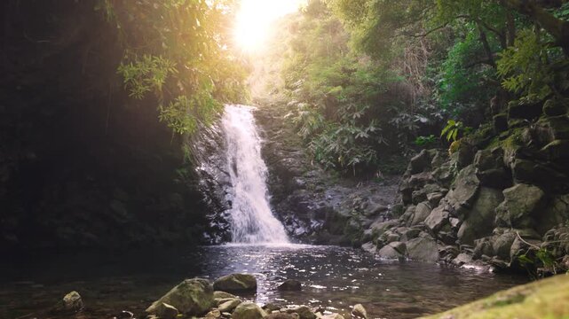 Waterfall with sunshine in secluded forest on S&atilde;o Jorge Island Azores