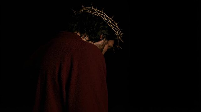 Man with crown of thorns in a red robe, suffering for christianity, on Good Friday. Religious biblical concept for Easter.