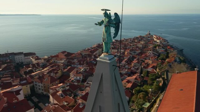Epic Aerial Pull Back from Archangel Michael Statue to Piran Peninsula: Slow Motion Reveal of St. George's Church and Entire Cape, Winter Golden Hour Sunset, Slovenia Mediterranean Heritage 4K