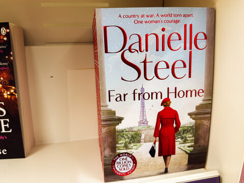 Danielle Steel Far From Home Book Cover on a Shelf with Paris Skyline and a Red Coat Woman