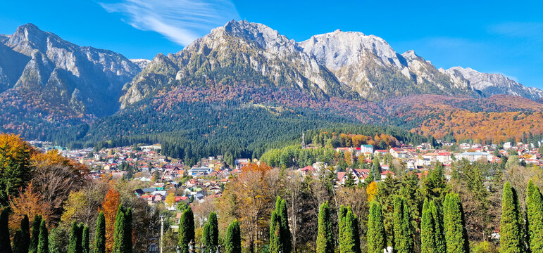 Scenic autumn mountain landscape with cypress trees and colorful foliage in Busteni, Romania
