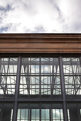 Glass building against a cloudy sky