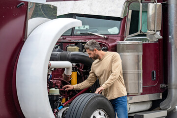 Transportation vehicles. Semi trucks vehicle. Hispanic man trucker. Handsome man driver in front of...