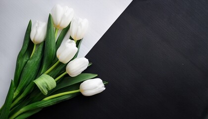 White Tulips Bouquet On Black And White Paper Flat Lay
